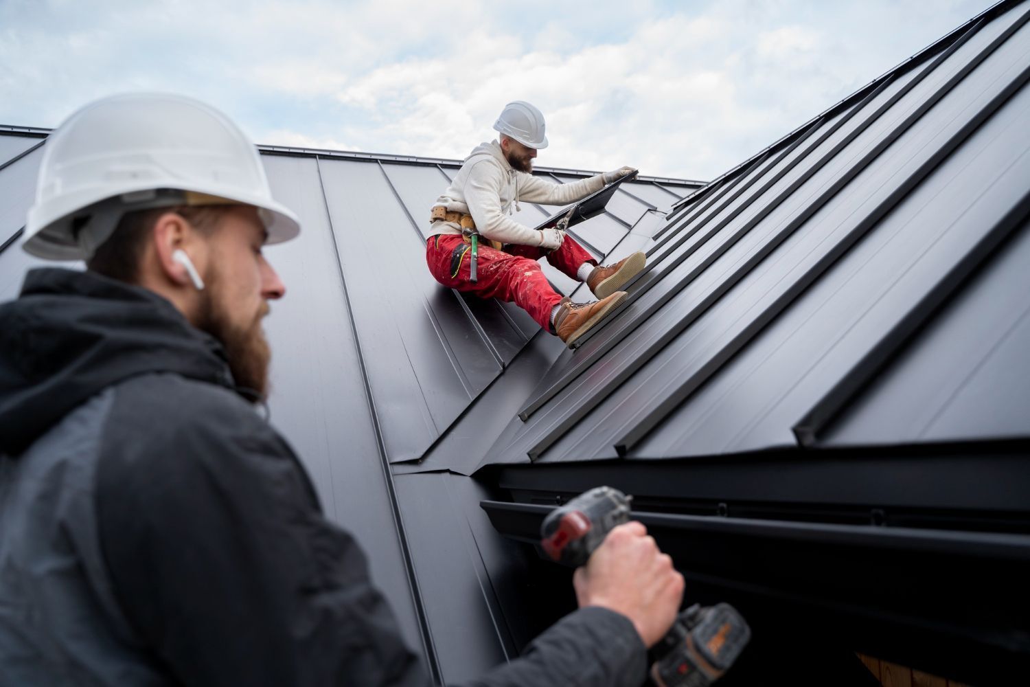 A group of men are working on the roof of a building.